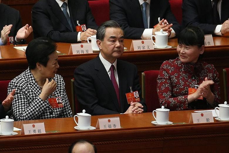 Foreign Minister Wang Yi has been promoted to state councillor - a position just below that of vice-premier - while retaining his current portfolio.
