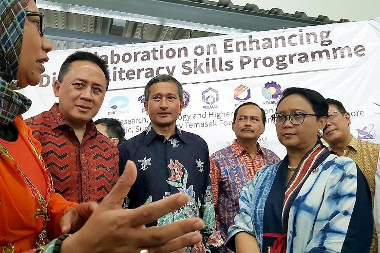 Singapore Foreign Minister Vivian Balakrishnan and his Indonesian counterpart Retno Marsudi (in blue dress) on a tour of Nongsa Digital Park, which was launched yesterday. With them were (from left) Dr Paristiyanti Nurwardani of the Indonesian Minist