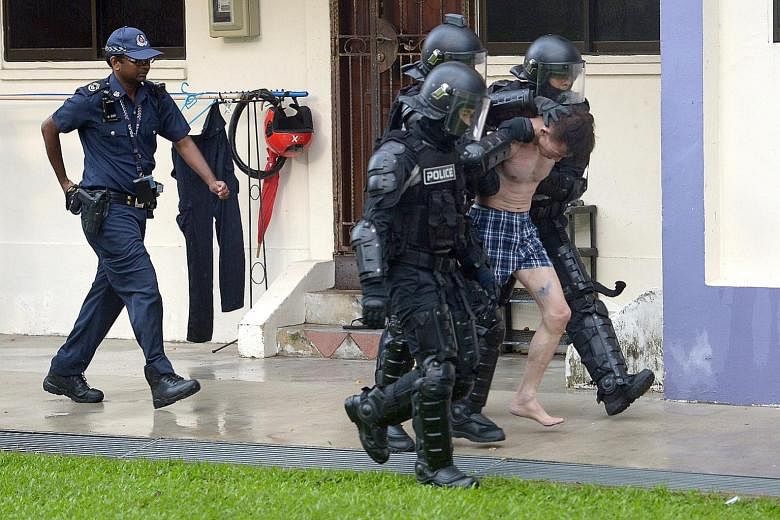 Officers from the Special Operations Command knocked down the door of the flat where the man was and led the suspect out. He was arrested for criminal intimidation and suspected drug-related offences.
