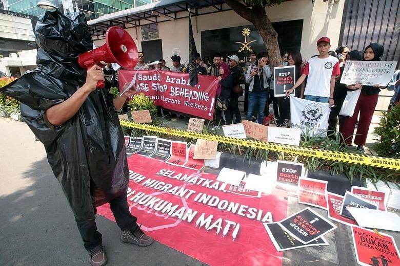 An Indonesian activist speaking during a protest in front of the Saudi Arabian Embassy in Jakarta yesterday against the beheading of Indonesian migrant worker Muhammad Zaini Misrin, 53, on Sunday. Zaini, who had worked as a driver in Saudi Arabia, wa