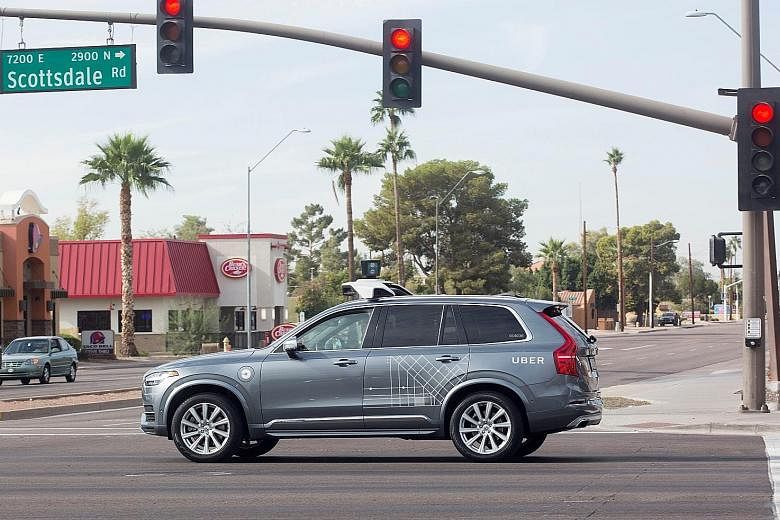 An Uber car, also a Volvo like this one (left), was in autonomous mode with an operator behind the wheel when it struck and killed a woman at this intersection (above) on Sunday in Tempe, Arizona.