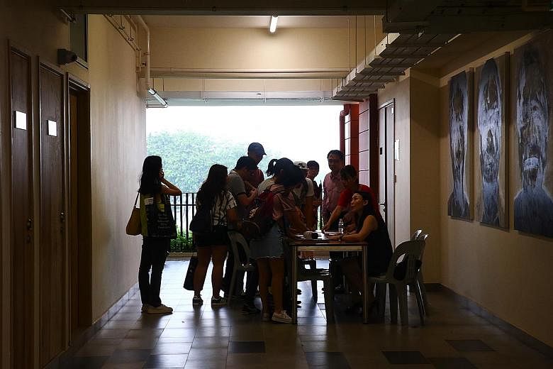 Affected Hwa Chong Institution students checking their names against a register before attending a briefing last month about their missing exam papers.