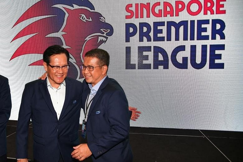 FAS president Lim Kia Tong (left) and vice-president Edwin Tong presenting the league's new logo, which features a red and blue roaring lion - the colours of Singapore and the FAS, respectively.