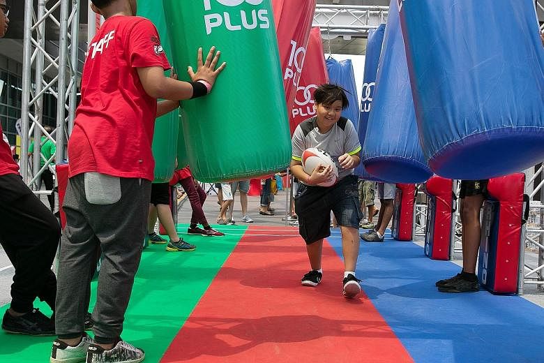 A boy having fun at the kids' zone during the tournament two years ago. There will be plenty of fringe activities for families at the HSBC Singapore Sevens competition at the National Stadium at the end of next month.