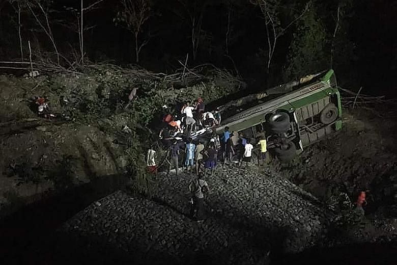 Rescue workers searching for survivors in the passenger bus, which veered off a road and plunged into a ravine near Sablayan town, about 195km south of Manila, yesterday. The bus company involved in the crash has been suspended.