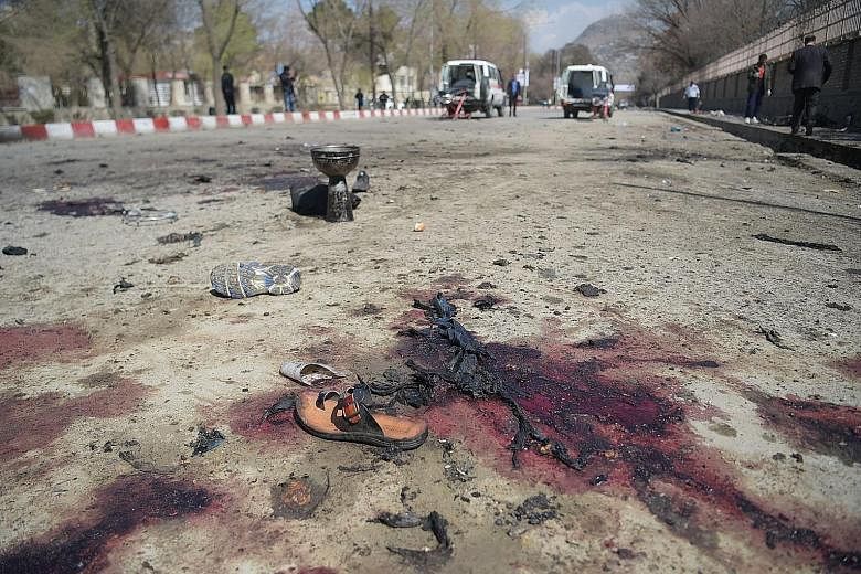 Victims' footwear left at the site of the bombing near the Kart-e Sakhi shrine in Kabul yesterday. The bomber had reportedly tried to reach the shrine but was prevented from getting closer by police checkpoints.