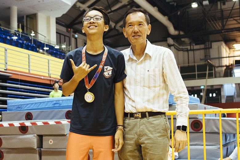 Louis Ang, 16, the B Division individual champion from Whitley Secondary, with East Spring Secondary principal Teoh Teik Hoe.