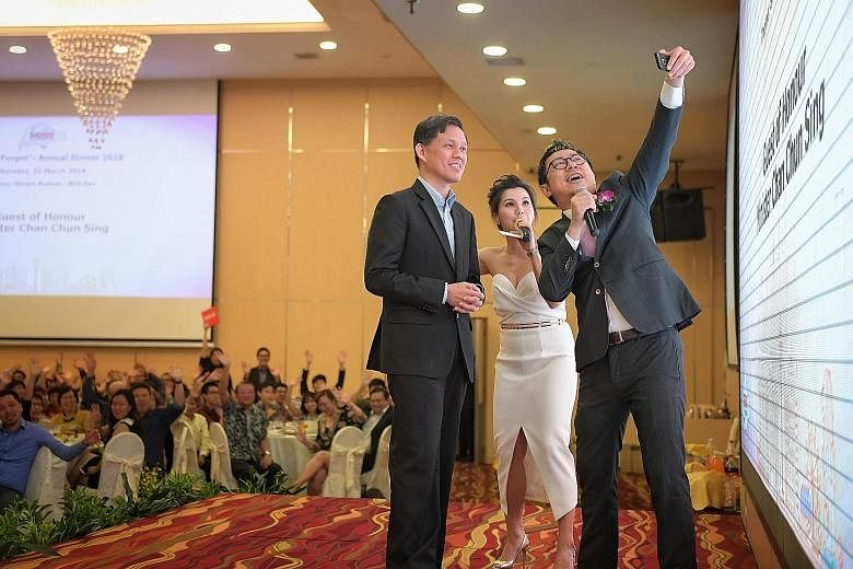 Minister in the Prime Minister's Office Chan Chun Sing taking a wefie with emcees Charissa Seet and Eugene Seah at the SG100 Foundation's dinner at the Singapore Expo last night.