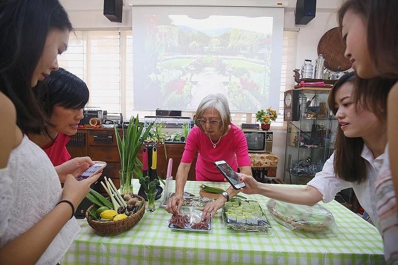Madam Maria Yee sharing how she uses herbs and plants she grows in her cooking at the Touch Seniors Activity Centre in Geylang Bahru. She says the Airbnb tie-up gives her a chance to share her love for gardening.