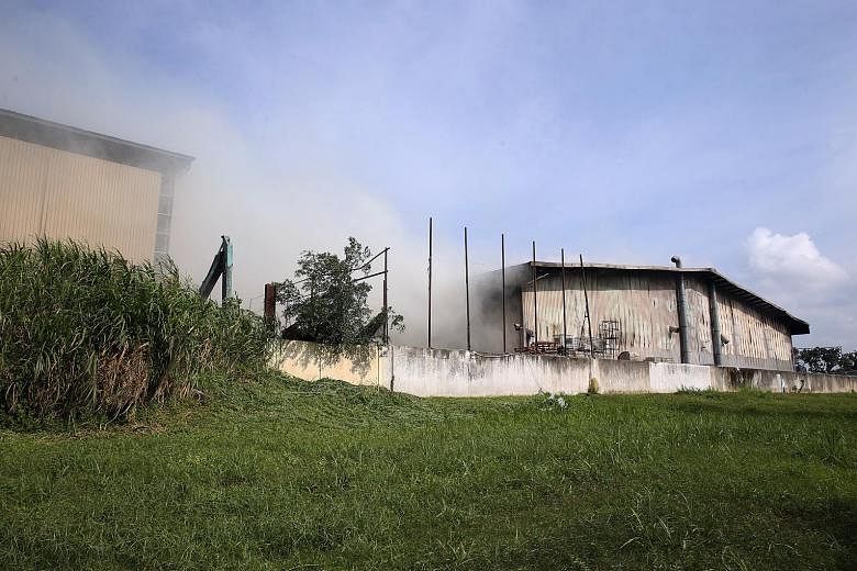 SCDF said the fire had involved waste materials contained inside the building, which are "typically deep seated and difficult to be extinguished quickly". Thick smoke surrounding the warehouse in Kranji Crescent. The facility is operated by waste man