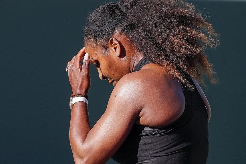 Naomi Osaka hitting a return during her first-round Miami Open win over Serena Williams (above), who cut a dejected figure after her defeat and skipped the post-match press conference.