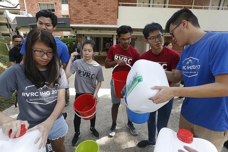 Students - and staff - of Ridge View Residential College brushed their teeth (above), washed their hands and bathed using jerry cans and buckets (right) yesterday as part of NUS' save-water campaign.