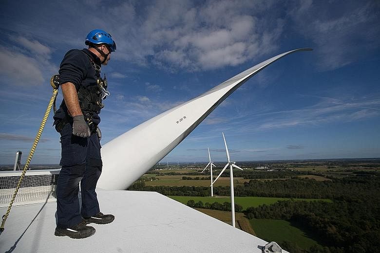 An Engie technician inspecting a wind turbine at its wind farm in Radenac in Brittany, France. The firm is increasingly targeting contracts where it makes more money if it meets energy reduction goals. It is focusing on air cooling and heating, lighting a