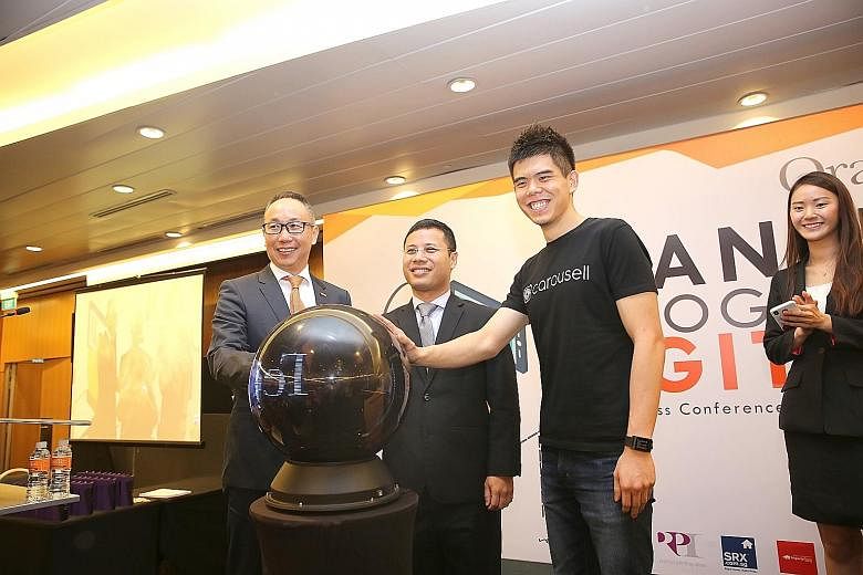 (From left) OrangeTee & Tie managing director Steven Tan, Second Minister for National Development Desmond Lee and Carousell co-founder and chief executive Quek Siu Rui at the property agency's business conference yesterday. With the tie-up, property