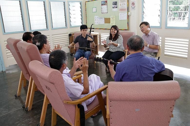 Social work co-ordinator Regina Mary, 48, with volunteers (from far left) Ryan Teo, 21, Chris Koh, 65, and Chio Cheng Kay, 76, (back to camera, with guitar) enjoying a singing session with TB patients.