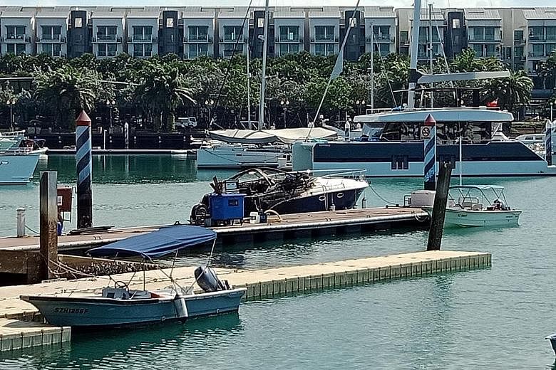The charred yacht was still at the fuel dock when The Straits Times visited the ONE°15 marina at about 10.30am yesterday. It was towed away at about 12.30pm.