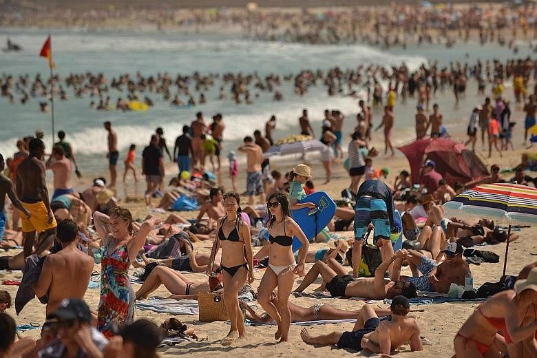 People enjoying the hot weather at Bondi Beach in Sydney. Out of Australia's population of about 25 million people, about five million live in Sydney and 4.7 million in Melbourne.