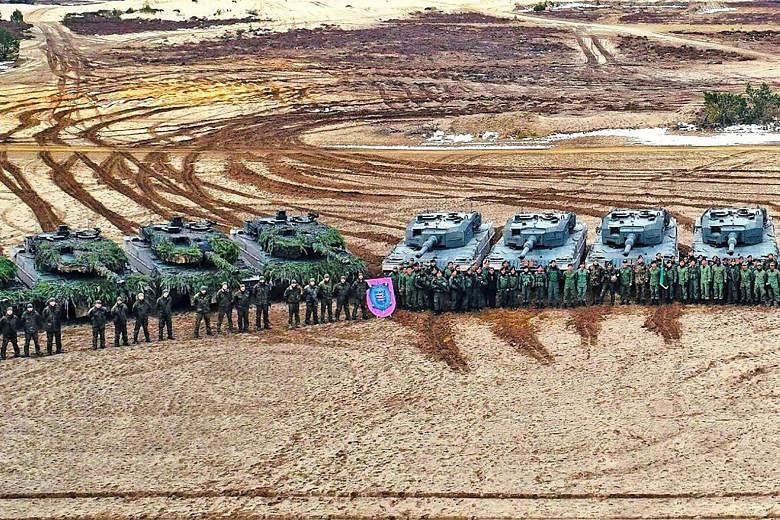 The Singapore Armed Forces' Leopard 2SG Main Battle Tanks (MBTs) (right) and the German Army's Leopard 2A6 MBTs (left) in bilateral training as part of Exercise Panzer Strike.