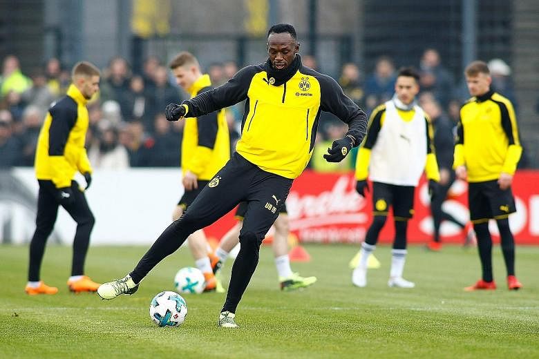 Usain Bolt during his first training session with Borussia Dortmund yesterday. He scored with a header and nutmegged one opponent by knocking the ball between his legs.