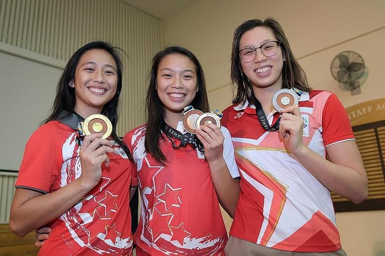 (From left) Fong Kay Yian and Ashlee Tan (diving) and Chantal Liew (open water swimming) were presented with their upgraded medals.