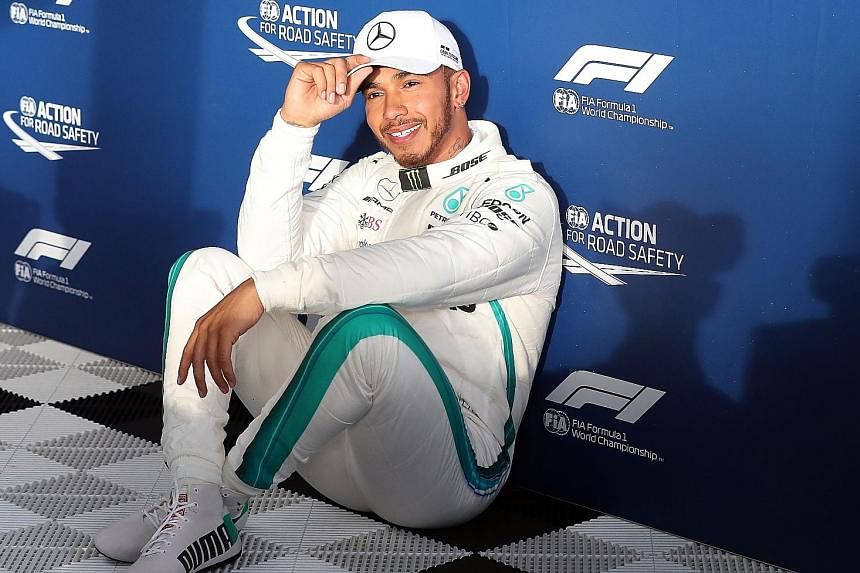 Top: Valtteri Bottas crashed on his first attempt at a flying lap at Albert Park yesterday and his car will have to be fitted with a new gearbox. Above: Lewis Hamilton after taking pole with a record lap of 1min 21.164sec. With him on the front row i