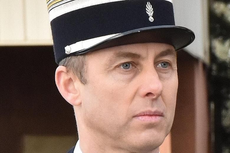 Above: Lieutenant-Colonel Arnaud Beltrame, who once served in Iraq, was rushed to hospital after being shot three times by the Islamist militant but died later. Right: A French gendarme outside the Super U store in the southwestern town of Trebes yes