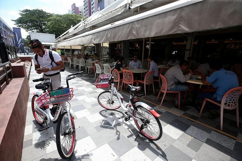 SG Bike operation supervisor Syed Al-Syahab, who found two of the firm's bikes parked illegally in the middle of a walkway, about to take them to an approved parking spot. In the six months at the firm, Mr Syed has also dealt with bikes with damaged 