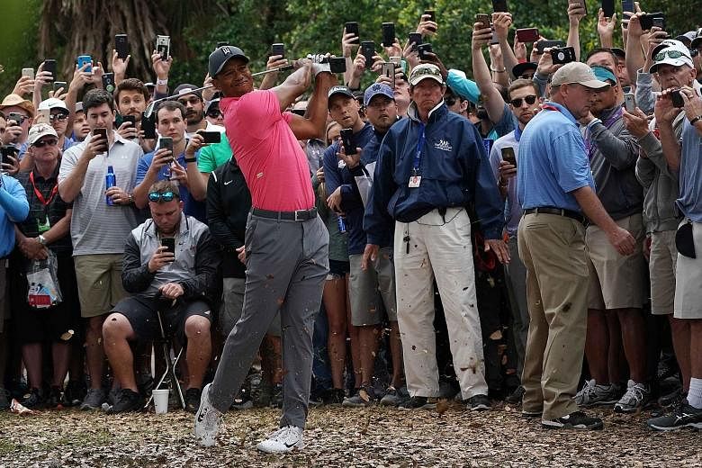 Tiger Woods playing a shot from the gallery during the third round of the Valspar Championship.