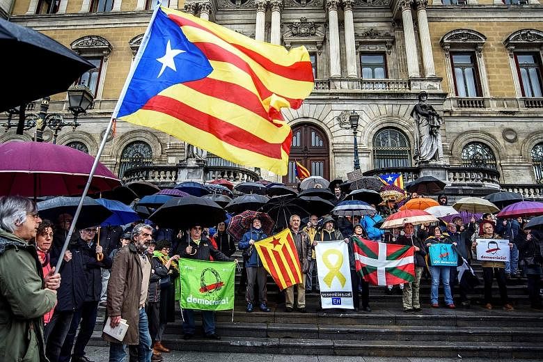 A protest in Bilbao, Spain, in support of imprisoned Catalan politicians yesterday. German police said they arrested Carles Puigdemont (below) on a European warrant issued by Spain.