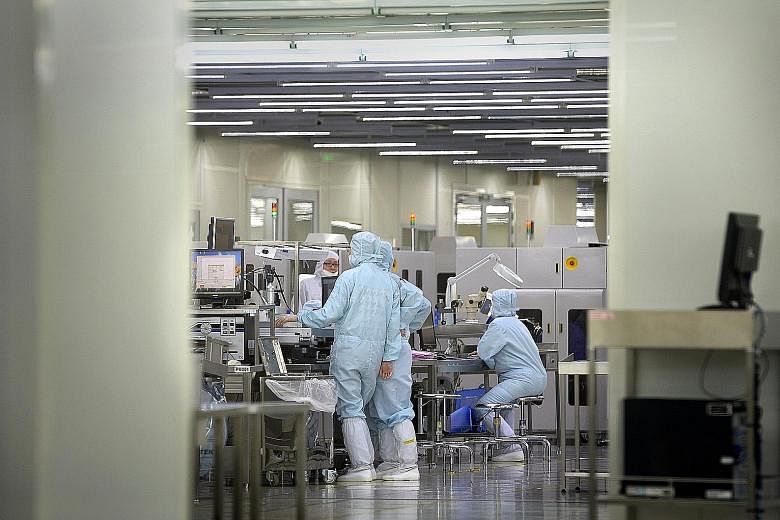 Workers at a Singapore semiconductor facility. Electronics' rise was due mainly to the semiconductors segment, which grew 26.7 per cent. General manufacturing fared the worst, with output declining by 6.3 per cent year-on-year.