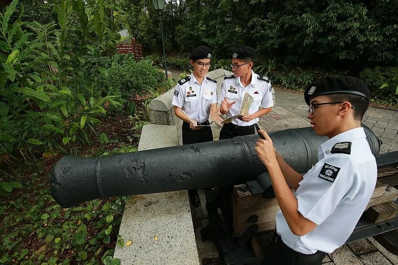 Students (from left) Jonathan Lim, Ethan Ong and Ethan Christian Tan from the St John uniformed group at Anglo-Chinese School (Independent) checking out a cannon at Fort Canning Hill, which was a landmark covered under their heritage trail projects.