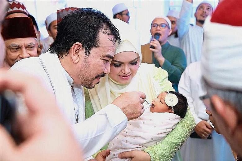 Siti Nurhaliza with her newborn daughter Siti Aafiyah and husband Khalid Mohamad Jiwa.