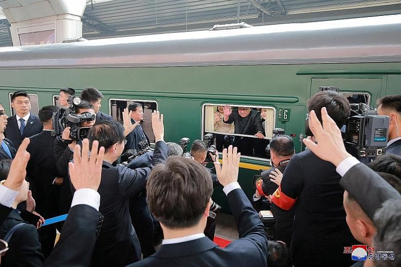 Mr Kim meeting Chinese officials inside a special train in an undisclosed location on Tuesday. The train he travelled in to Beijing was painted in drab green, and had 21 cars that were bulletproof. North Korean leader Kim Jong Un waving from his trai