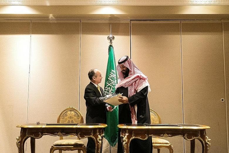 SoftBank chief executive Masayoshi Son and Saudi Crown Prince Mohammed bin Salman after signing their agreement on a solar power project - expected to have the capacity to produce up to 200 gigawatts by 2030 - on Tuesday.
