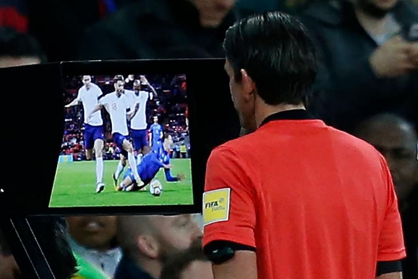 Left: England's James Tarkowski fouling Italy's Federico Chiesa at Wembley on Tuesday, resulting in a penalty following a (Video Assistant Referee) VAR review. Below: German referee Deniz Aytekin studying the VAR screen before reversing his decision 