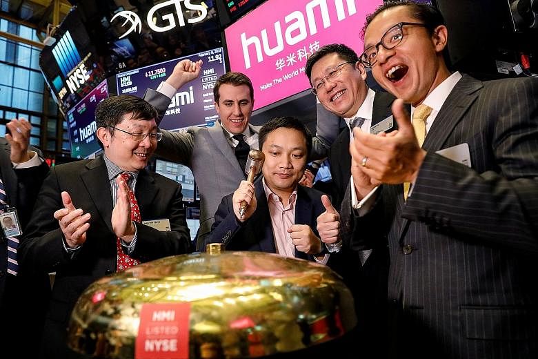 Huami Corporation chief executive Wang Huang ringing a ceremonial bell to celebrate his company's IPO at the New York Stock Exchange last month.