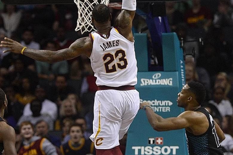 LeBron James dunking the ball on the way to 41 points at Charlotte's Spectrum Centre. That makes it the 866th straight game the Cleveland star has scored at least 10 points, a record he shares with Michael Jordan.