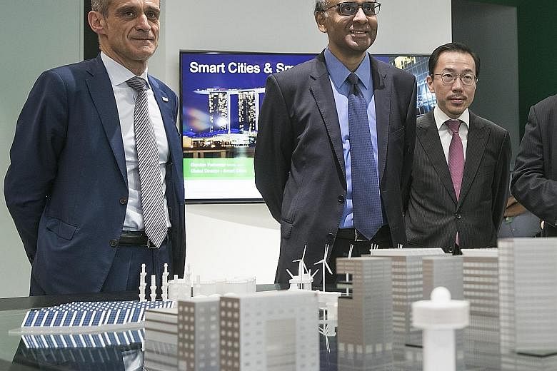 From left: Schneider Electric's chairman and chief executive Jean-Pascal Tricoire, Deputy Prime Minister Tharman Shanmugaratnam and Economic Development Board chairman Beh Swan Gin at the firm's East Asia and Japan headquarters (below) in Kallang, wh