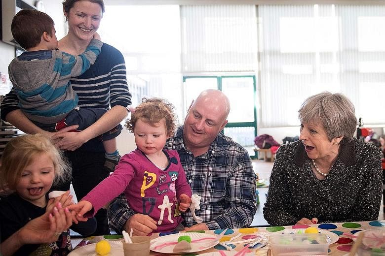 British Prime Minister Theresa May meeting a parent and toddler group in Newcastle, north-east England, yesterday during a tour of the United Kingdom, 12 months before Britain leaves the European Union.