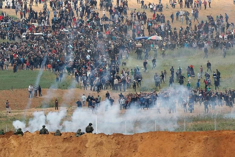 Tear gas being used during the Palestinian tent city protest yesterday at the Israel-Gaza border. Gaza officials said tens of thousands gathered to protest at five locations, while Israel's estimate was 17,000.