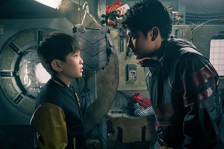 Steven Spielberg (far left) with Ready Player One author Ernest Cline. Tye Sheridan's character Wade Watts (left) watches as Olivia Cooke's Art3mis prepares to enter the world of virtual reality. Asian Hollywood newcomers Philip Zhao (left) and Win M