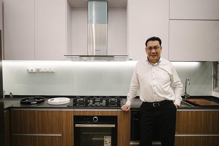 This showflat (above) in Gain City's Sungei Kadut store is the same size as a five-room Housing Board flat, says managing director Kenny Teo (below).