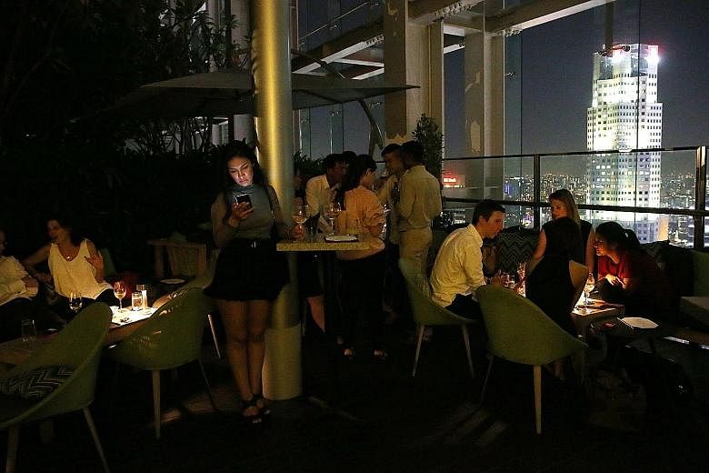 Mr Edouard Chamorel, 26, in his One Shenton apartment run by Hmlet, which handles 50 apartments and three buildings in Shenton Way, Raffles Place, River Valley and Joo Chiat. It organises rooftop parties for clients.