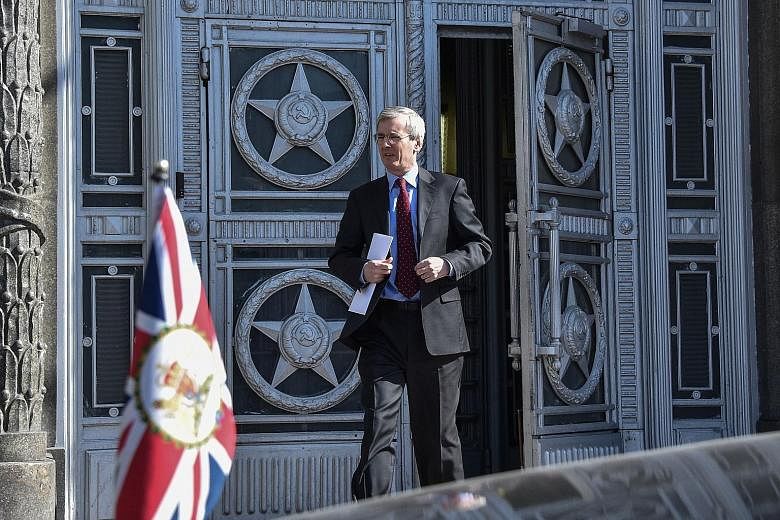 British ambassador to Russia Laurie Bristow leaving the Russian Foreign Ministry in Moscow on Friday, after being told he had one month to further cut Britain's diplomatic contingent in Russia to the same size as the Russian mission in Britain.