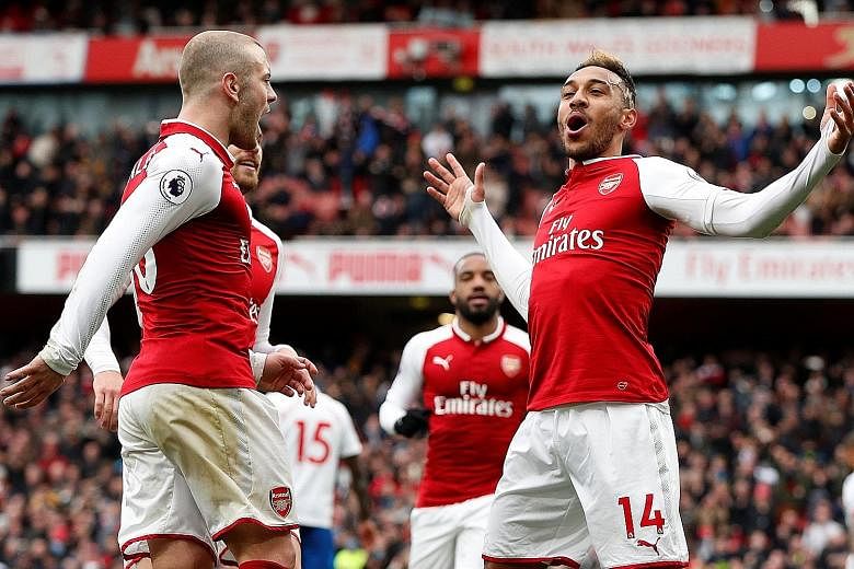 Arsenal's Pierre-Emerick Aubameyang celebrating breaking the deadlock against Stoke from the spot with team-mate Jack Wilshere. The Gabonese striker scored another from a corner before passing up the opportunity for a hat-trick, instead allowing stri