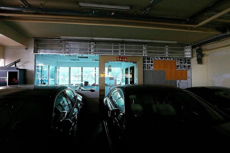 The signboard at Apex Car's premises in Ubi (above) has been removed, while at Novelty Auto in Kaki Bukit (below) the signboard hangs above an empty showroom. Novelty Auto has been operating for only about nine months. Case issued a public warning ag