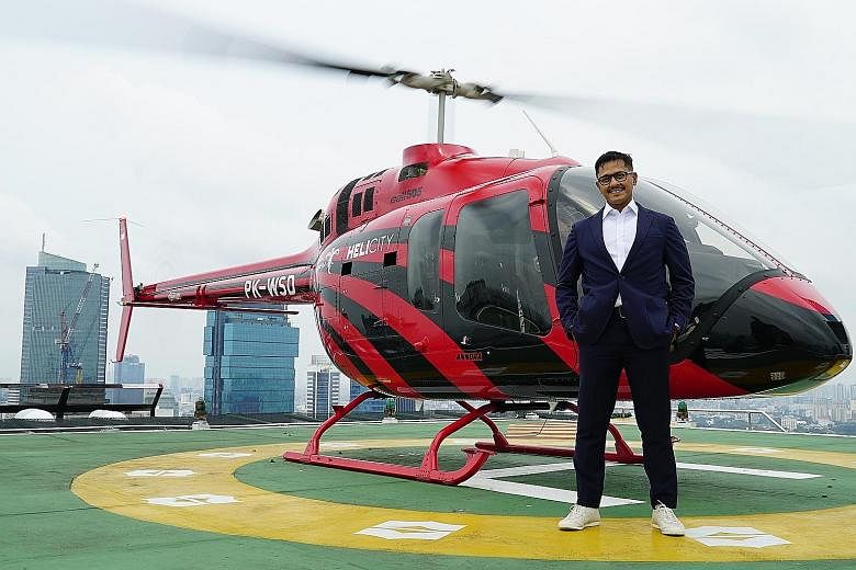 Above: A Bell 505 Jet Ranger helicopter flying over Jakarta. Left: Whitesky Aviation CEO Denon Prawiraatmadja on the helipad of Shangri-La hotel in Jakarta, currently one of the locations where customers can board or be dropped off.