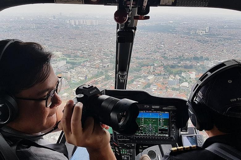 Left: Beating a traffic jam in Jakarta high above in a Helicity helicopter. Above: Arriving in style on the rooftop helipad at Shangri-La hotel. Below: Whitesky Aviation launched helicopter-taxi service Helicity which allows customers to book rides f