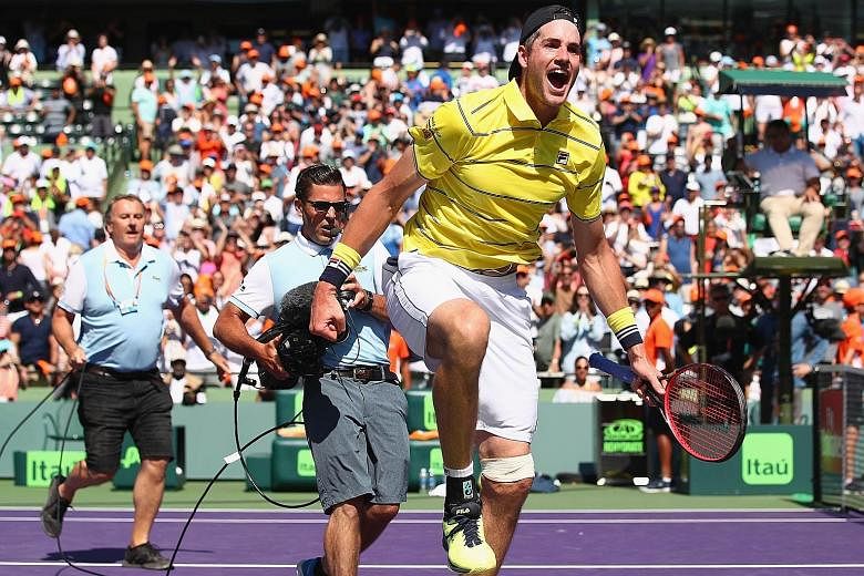 John Isner celebrating following his 6-7 (4-7), 6-4, 6-4 win over Alexander Zverev of Germany in the Miami Open final on Sunday. He became the first American since Andy Roddick in 2010 to lift the title.