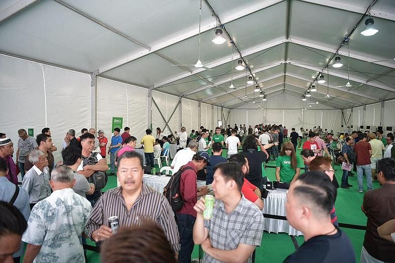 Drivers gathering yesterday in the carpark of Midview City in Sin Ming, where Grab's driver centre is located. Since last week, Uber drivers have been flocking to sign up with Grab.